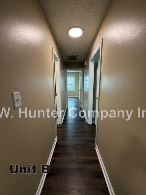 A long hallway with the words "Unit B" on the floor.