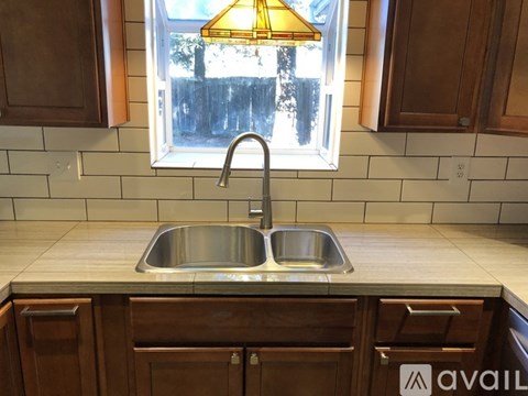 A kitchen with a sink and a window.
