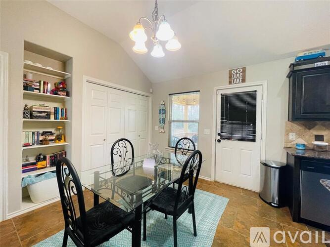 A dining room with a glass table and chairs.