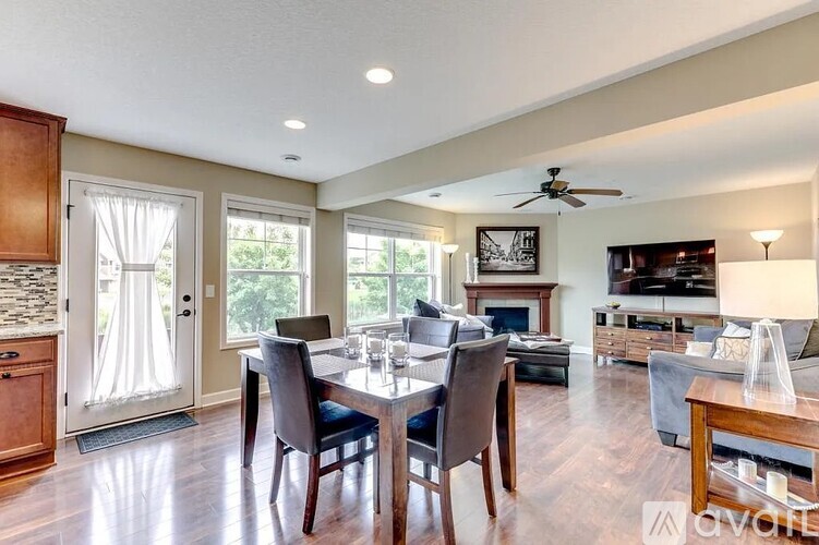 A well-lit dining room with a table set for four.