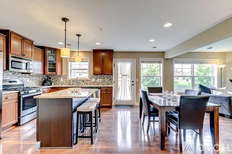 A modern kitchen with a dining table and chairs.