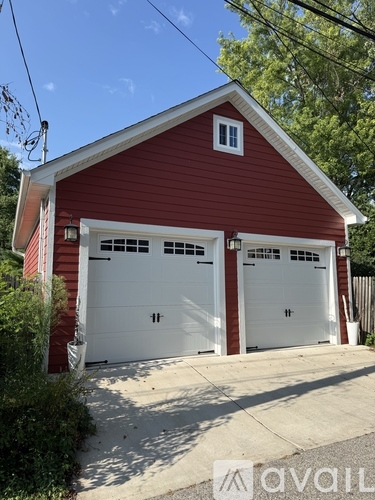 A red barn-style building with two white garage doors.