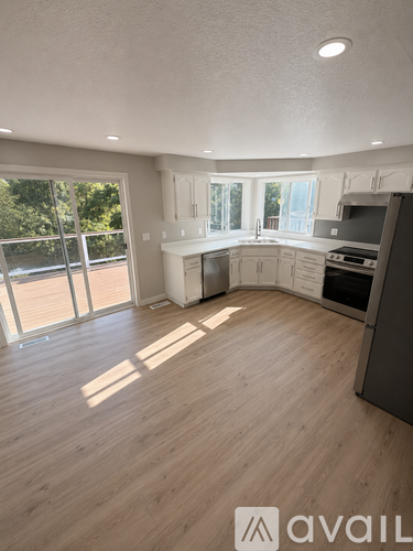 A modern kitchen with wooden floors and a large island.