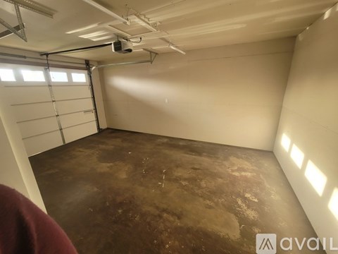 A room with a ceiling fan and a projection screen.