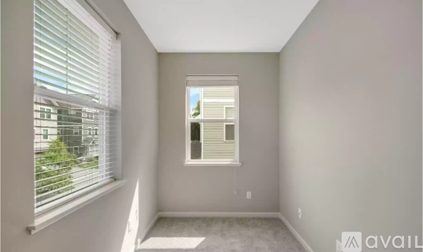 A room with a window and a view of a building outside.