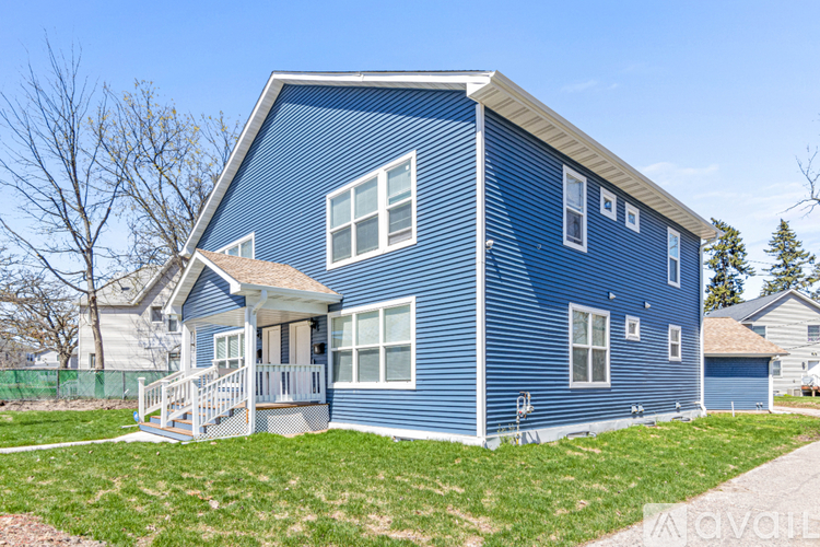 A blue house with a white porch.