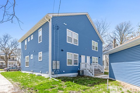A blue house with a white door and windows.