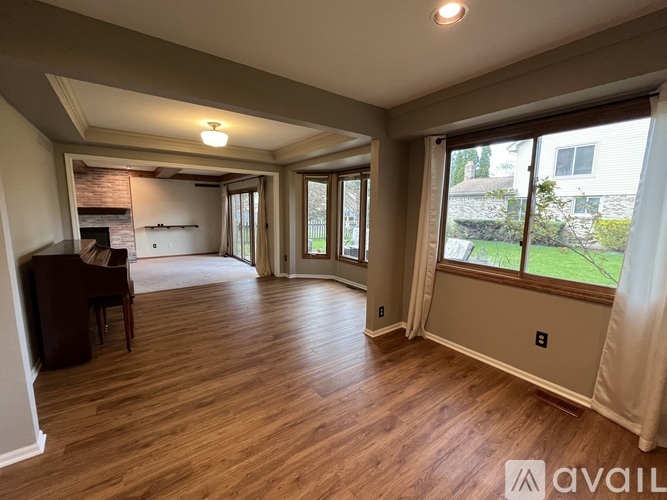 A living room with wood flooring and a fireplace.