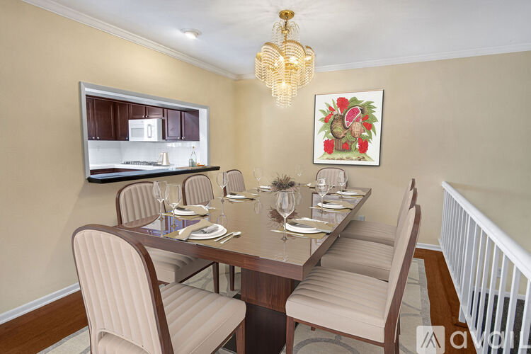 A dining room with a long table set for six people.
