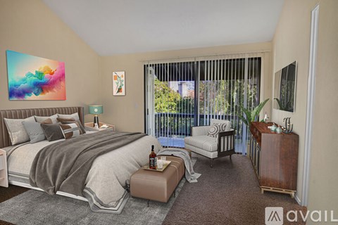 A bedroom with a large bed and a painting on the wall.