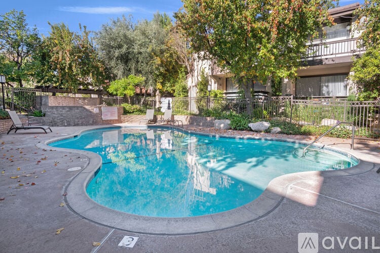 A small pool with a waterfall in the middle of it.