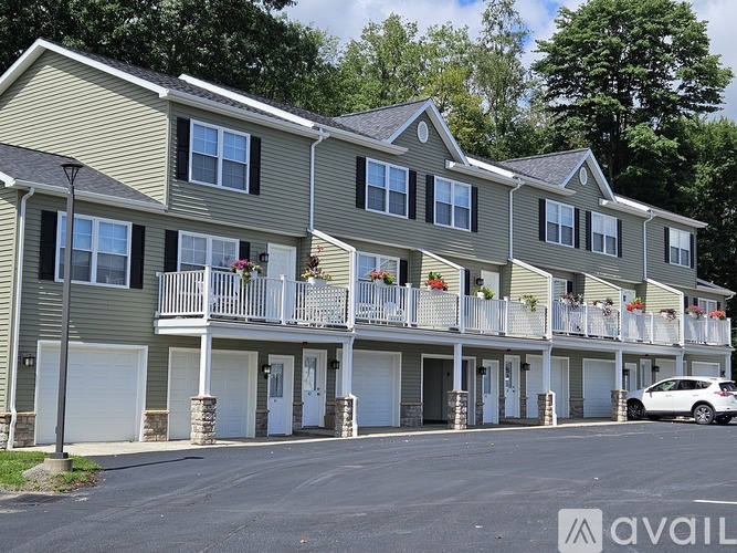 A row of townhouses with balconies and garages.