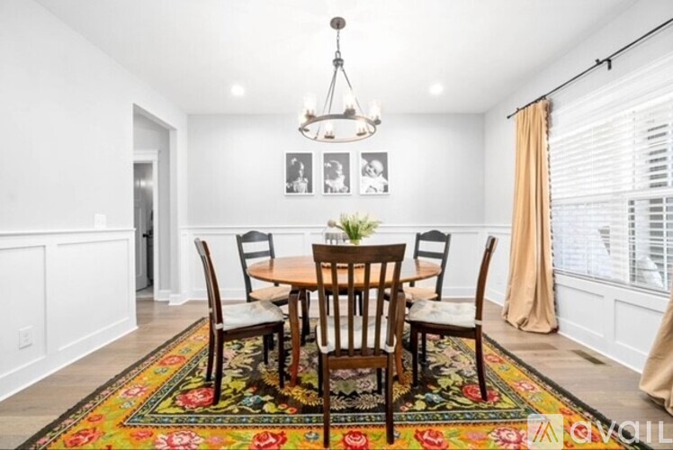 A dining room with a table set for four.
