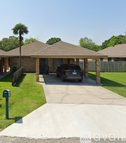 A house with a car parked in front.