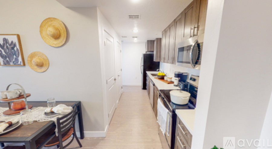 A kitchen with a table and chairs and a fridge.