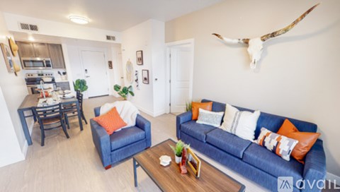 A living room with a blue couch and a wooden coffee table.