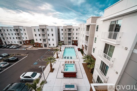 A pool in a courtyard surrounded by apartment buildings.