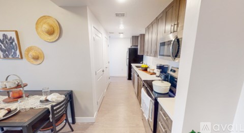 A kitchen with a table and chairs and a fridge.