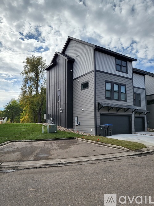 A modern two-story house with a garage and a driveway.