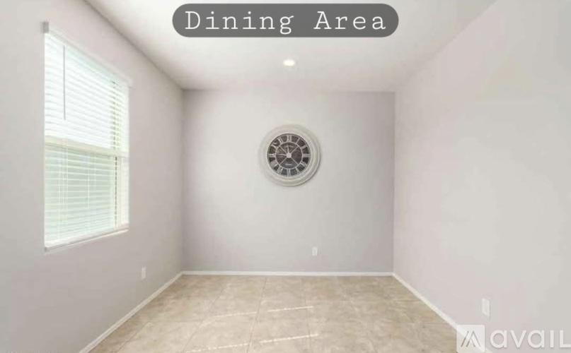 A dining area with a clock on the wall.