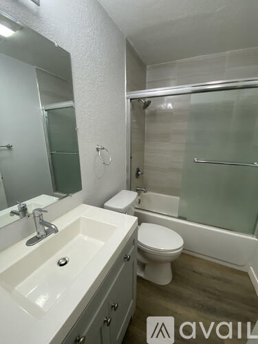 A bathroom with a sink, toilet and shower.