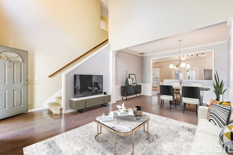 A living room with a white couch and a coffee table.