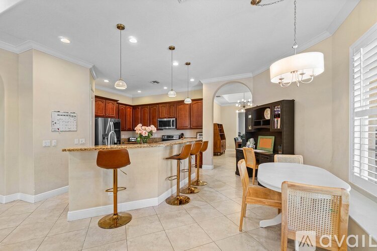 A kitchen with a bar area and a dining table.