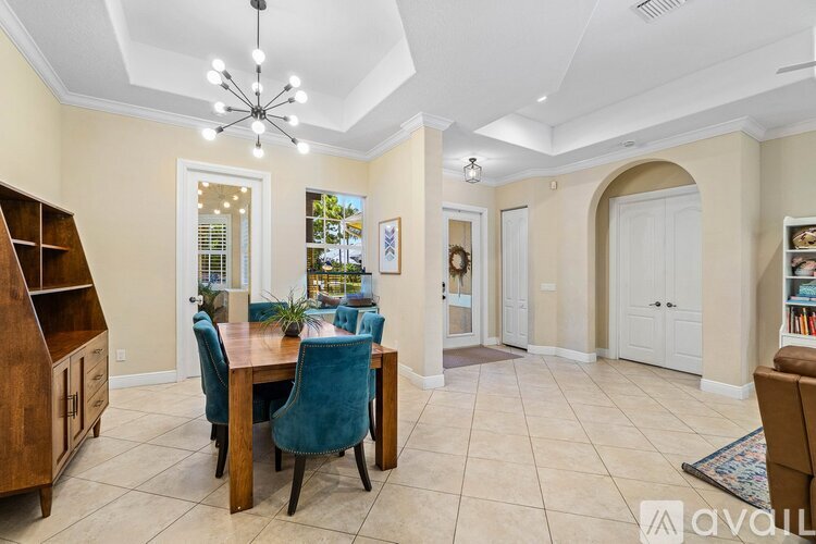 A dining room with a wooden table and chairs.