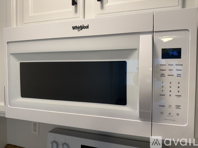 A white Whirlpool microwave oven with a digital display and control panel.