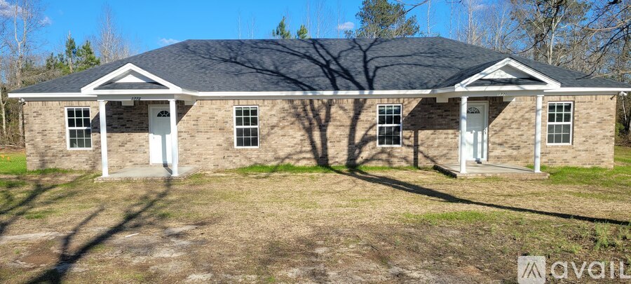 A house with a black roof and white trim is for sale.