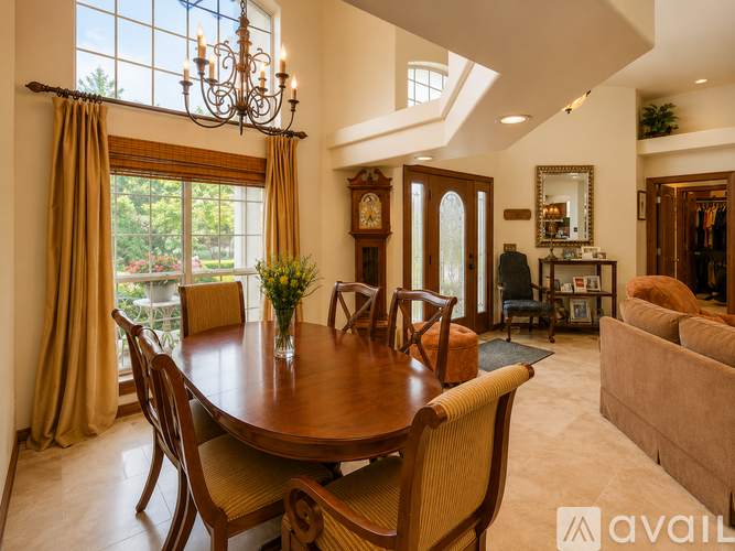 A dining room with a wooden table and chairs.