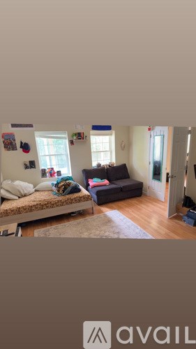 A living room with a couch and a bed.