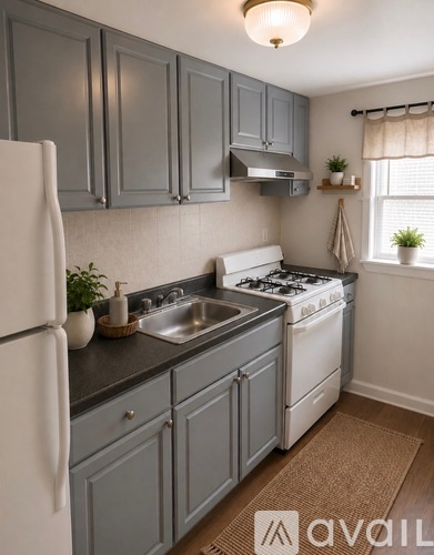 A kitchen with a white refrigerator and a white stove top oven.