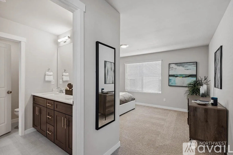 A well-lit, spacious bathroom with a vanity and a large mirror.
