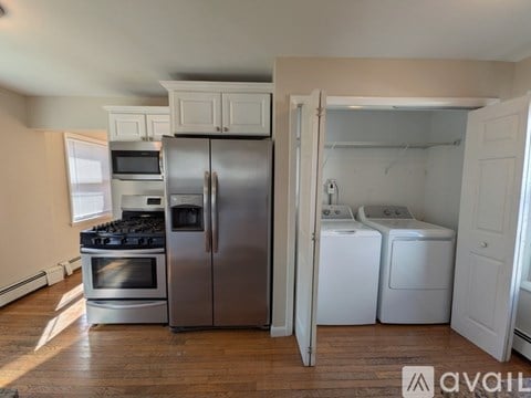 A kitchen with a stainless steel refrigerator, oven, and microwave.