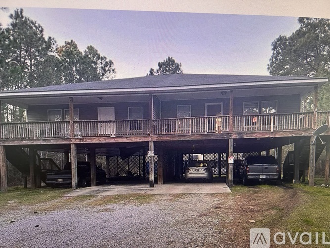 A large wooden house with a covered porch and a garage.