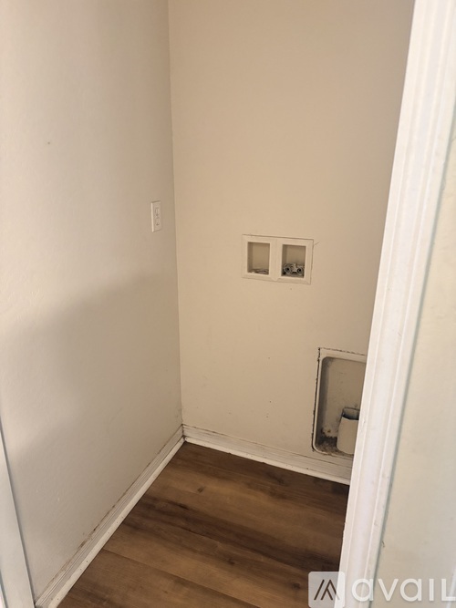 A room with a small window and a door cutout in the wall.