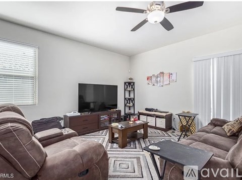 A living room with a brown couch and a television.