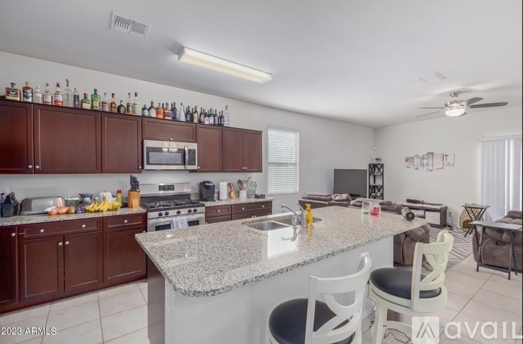 A kitchen with brown cabinets and a granite countertop.