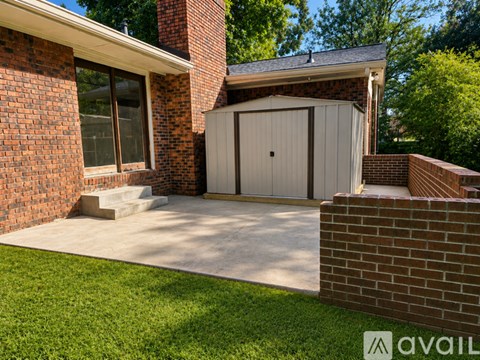 A house with a brick wall and a garage door.