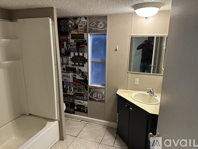A bathroom with a white sink and a shower.