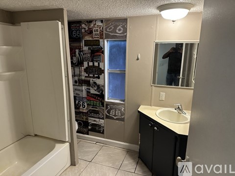 A bathroom with a white sink and a shower.