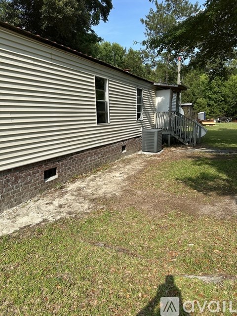 A house with a metal roof and a small porch.