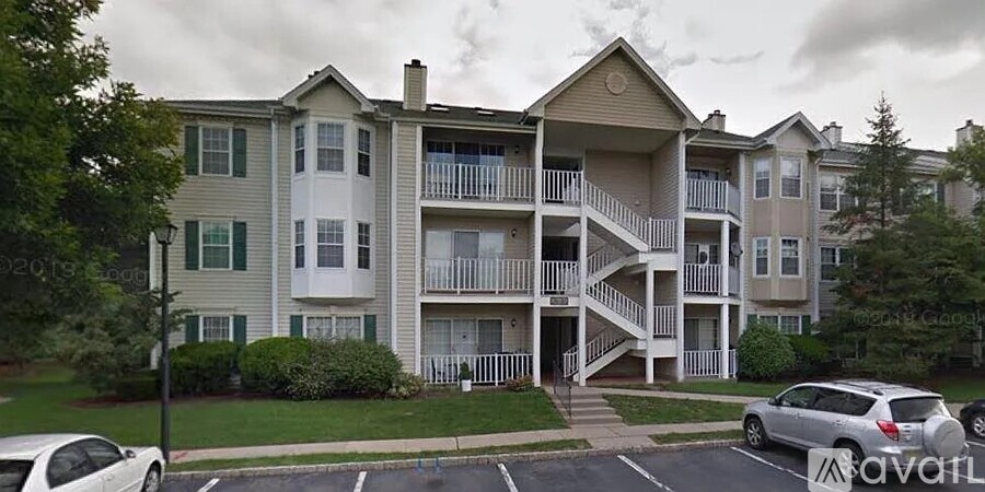 A large apartment building with a carport in front.