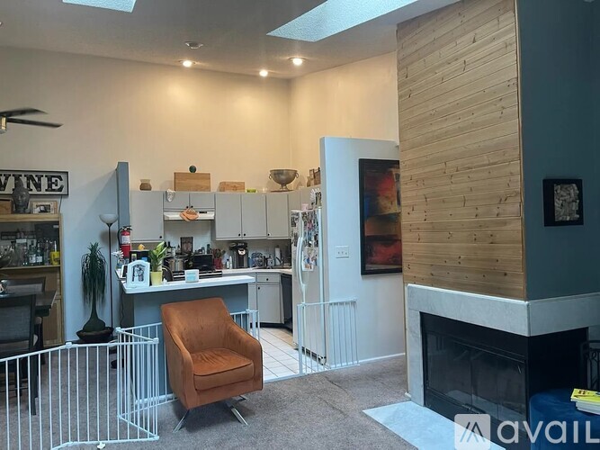 A living room with a fireplace and a chair.