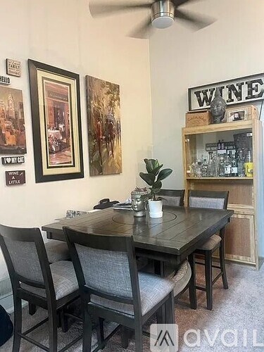 A dining room with a wooden table and chairs.