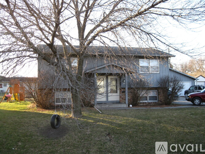 A house with a tree in front of it.