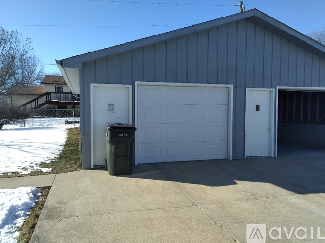 A two-car garage with a grey roof and white doors is available for rent.