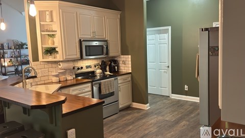 A kitchen with a stove top oven and a microwave.