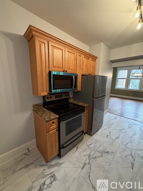 A kitchen with wooden cabinets and a black stove top oven.